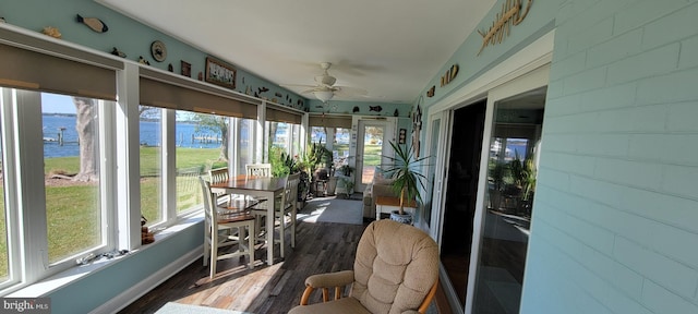 sunroom / solarium featuring plenty of natural light and ceiling fan