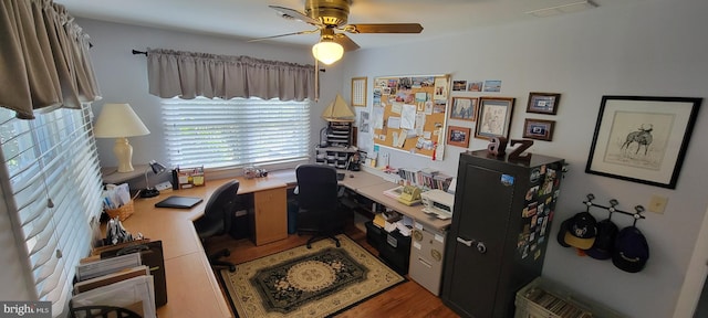 home office with ceiling fan, visible vents, and wood finished floors