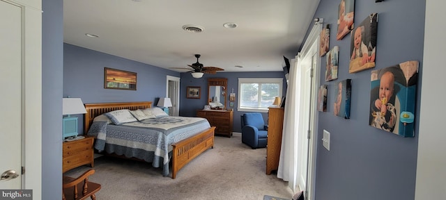 carpeted bedroom with visible vents and a ceiling fan