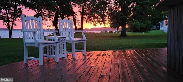 deck featuring a yard and a water view