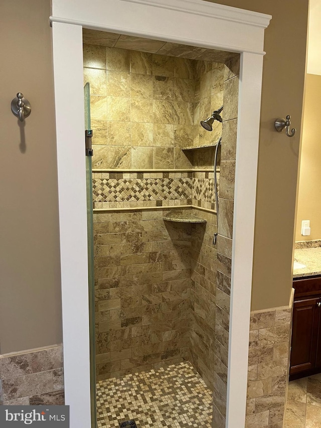 full bathroom with a stall shower and vanity