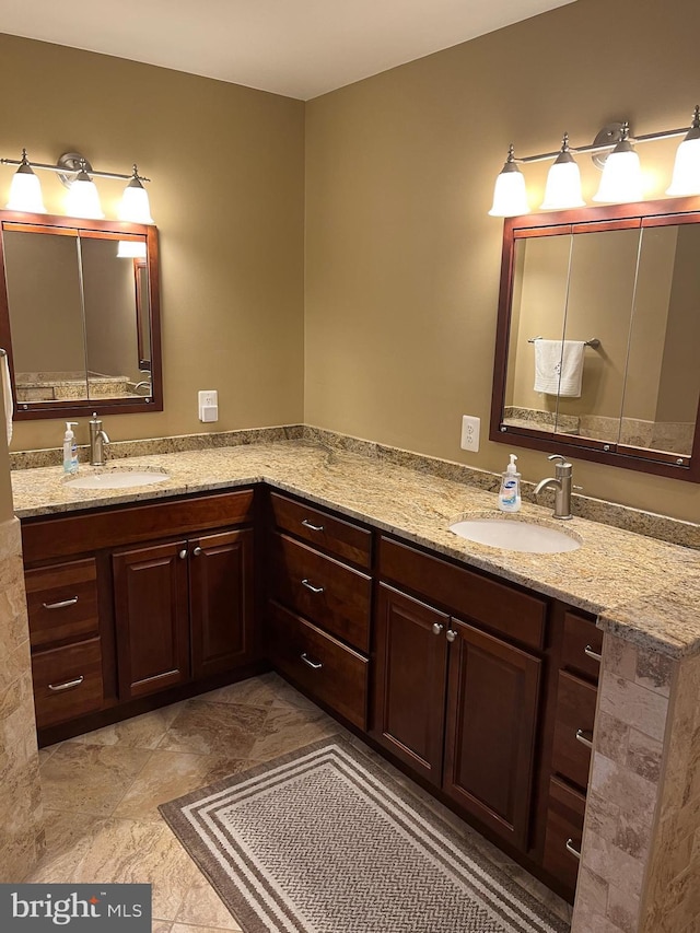 bathroom with a sink and double vanity