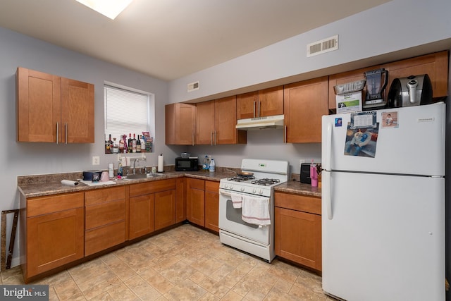 kitchen with sink and white appliances