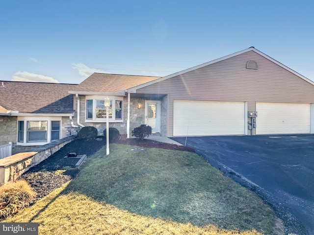 single story home with a garage and a front yard