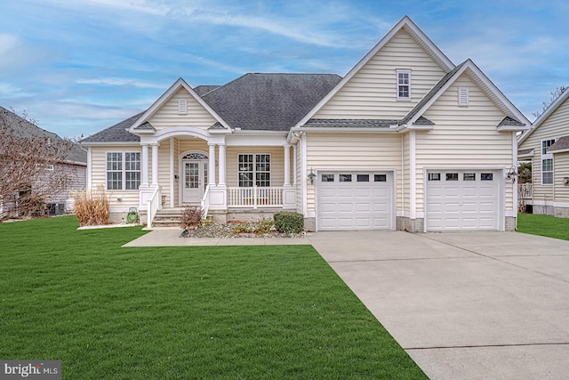 view of front of house with a front lawn, concrete driveway, and roof with shingles