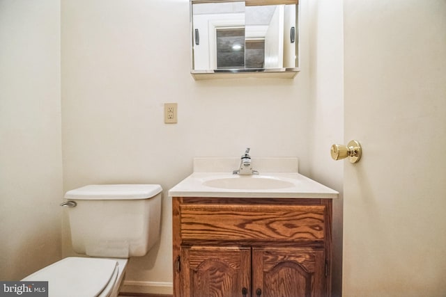 bathroom with toilet and vanity