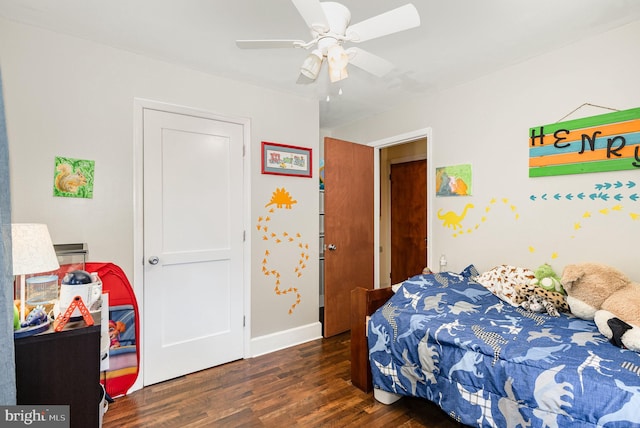 bedroom with ceiling fan, baseboards, and wood finished floors