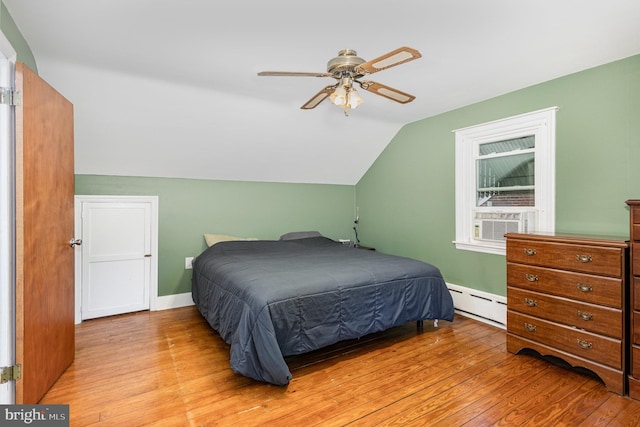 bedroom with a baseboard heating unit, cooling unit, ceiling fan, light wood finished floors, and lofted ceiling