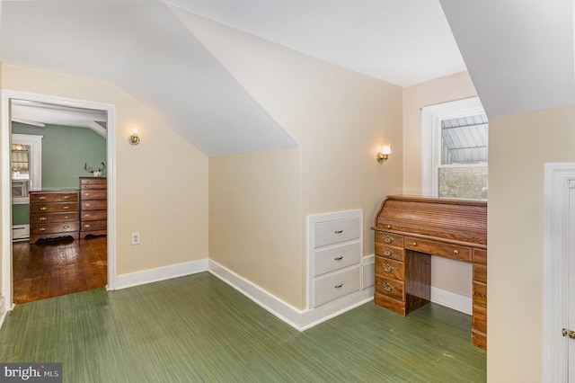 additional living space featuring lofted ceiling, a healthy amount of sunlight, wood finished floors, and baseboards