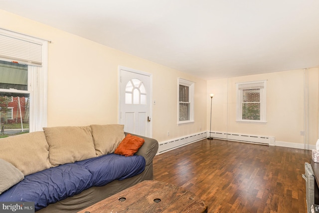 living area featuring dark wood-type flooring, baseboards, and baseboard heating
