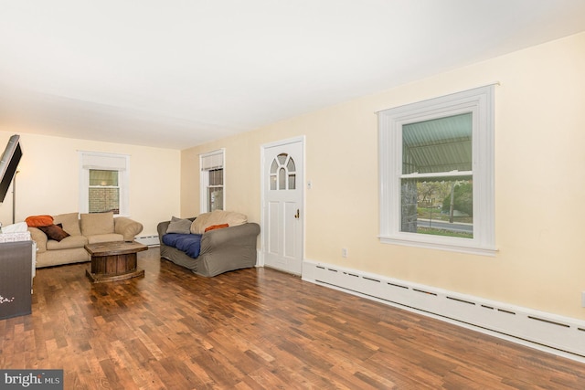 living area with baseboard heating, wood finished floors, and a baseboard radiator