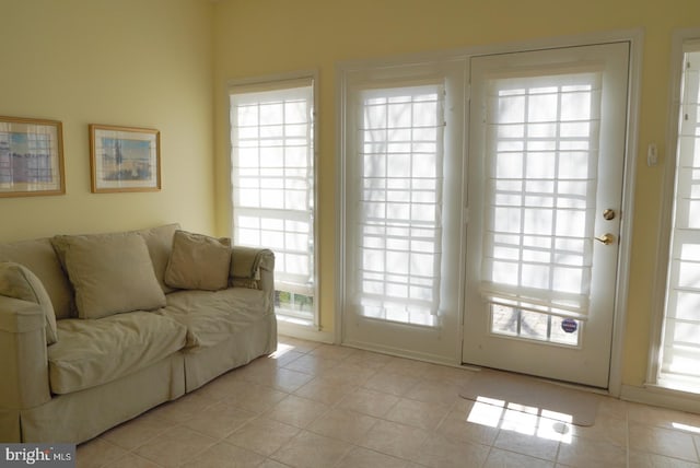 doorway with light tile patterned floors