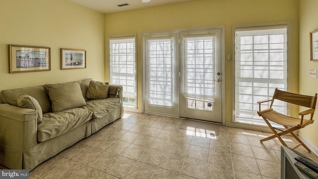 living room with light tile patterned flooring and visible vents