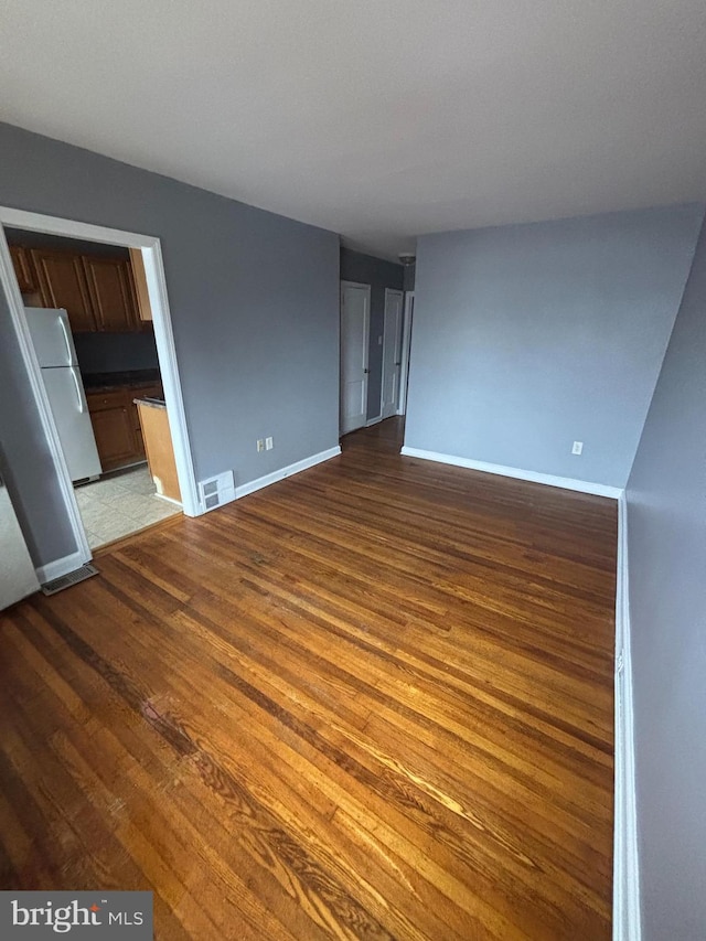 unfurnished living room with hardwood / wood-style floors