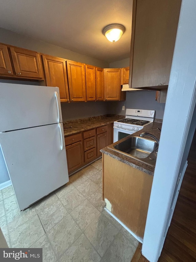 kitchen featuring sink and white appliances