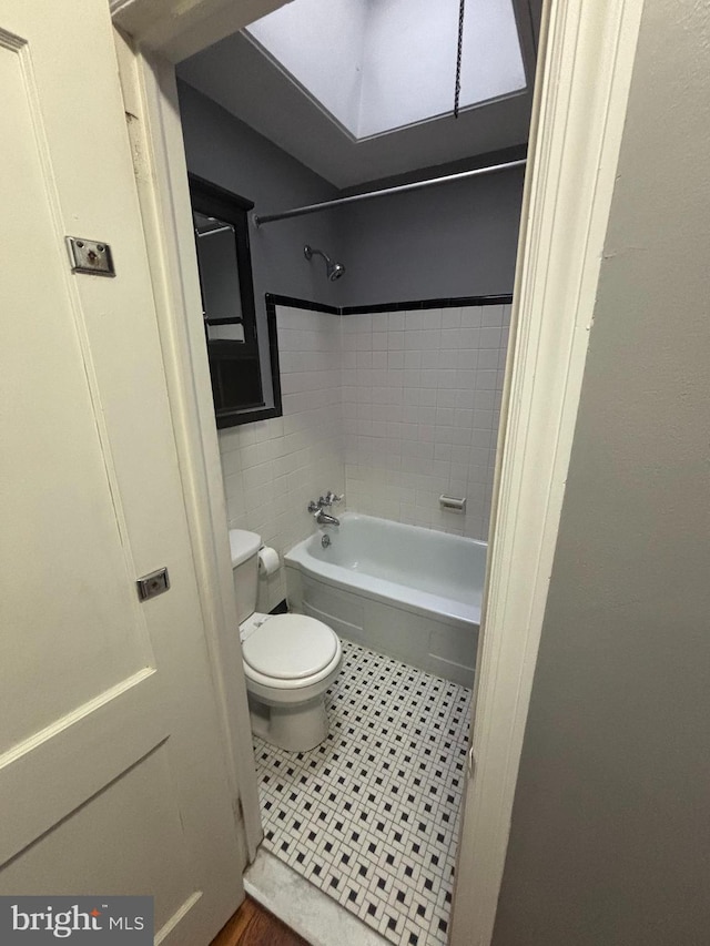 bathroom with tiled shower / bath and toilet