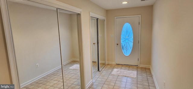 foyer with visible vents, baseboards, and recessed lighting