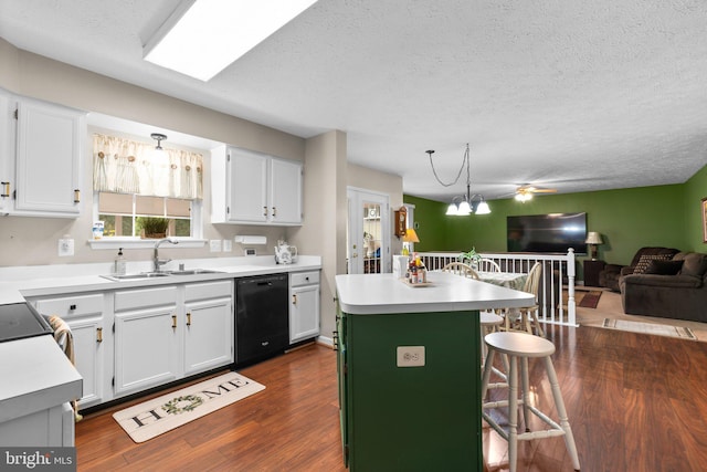 kitchen featuring sink, a breakfast bar area, white cabinetry, dishwasher, and a kitchen island