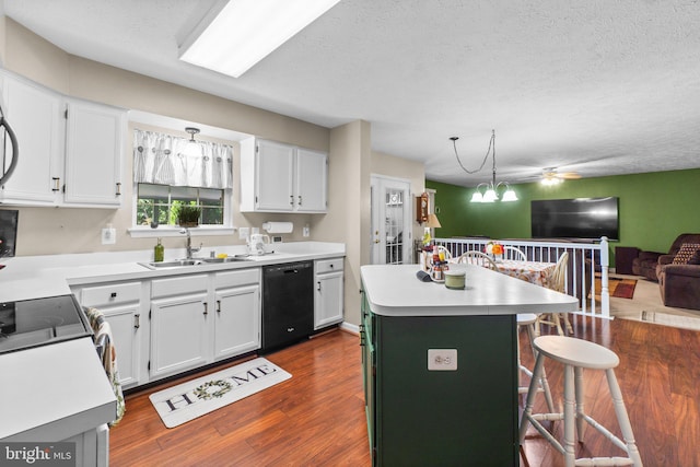 kitchen featuring a center island, black dishwasher, white cabinets, and a kitchen breakfast bar