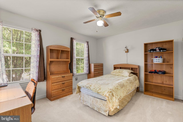 carpeted bedroom featuring ceiling fan