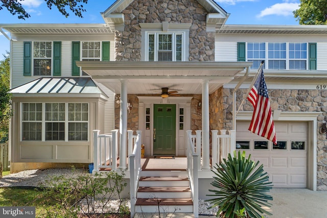 view of front of home featuring a garage and ceiling fan