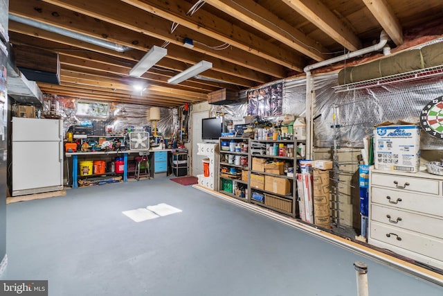 basement with white fridge