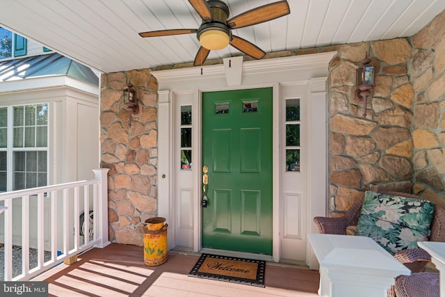 doorway to property featuring ceiling fan