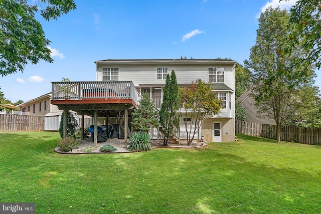 back of property featuring a wooden deck and a lawn