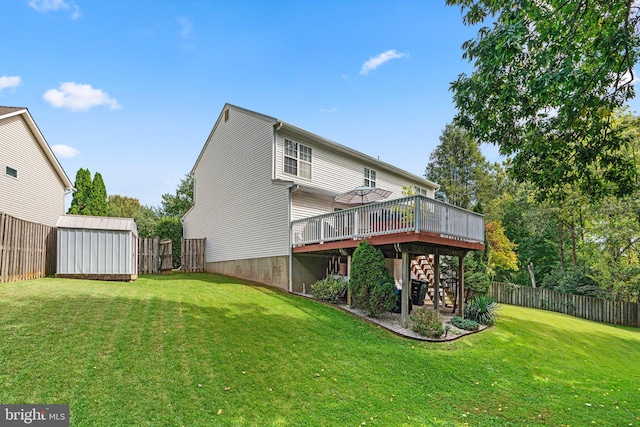 back of house with a wooden deck, a storage unit, and a lawn