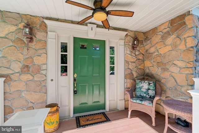 view of exterior entry with ceiling fan