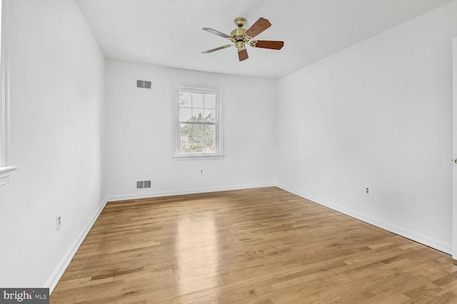 empty room with visible vents, baseboards, light wood-style floors, and ceiling fan