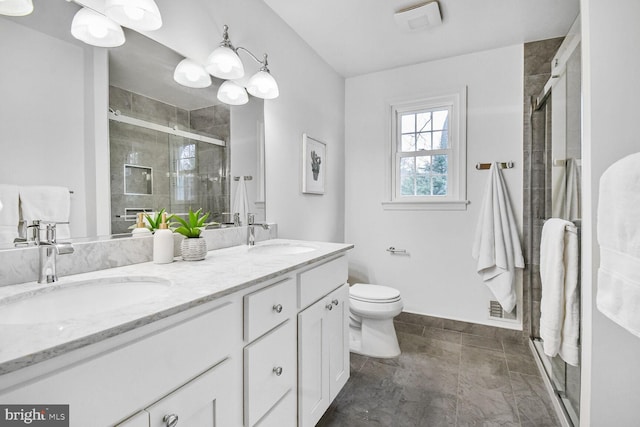 full bathroom with double vanity, a shower stall, toilet, and a sink