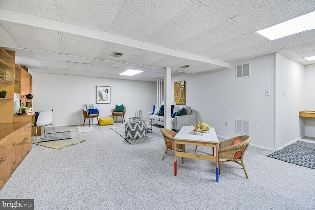 interior space featuring visible vents, a paneled ceiling, and carpet