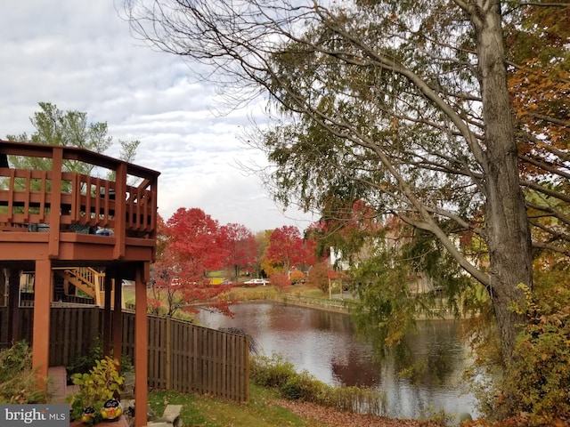 property view of water with stairs and fence