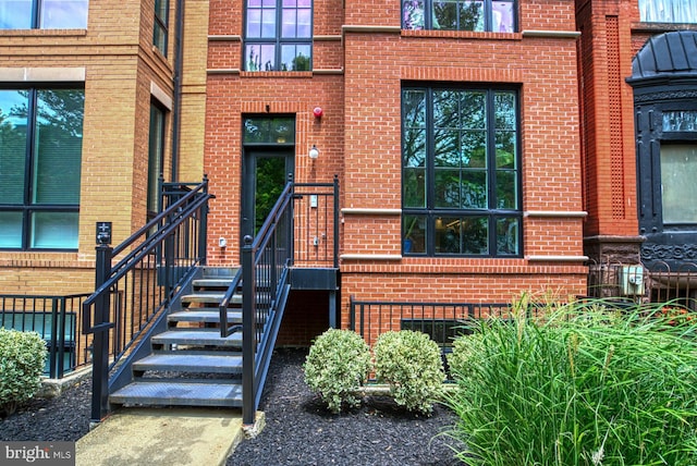 property entrance featuring brick siding