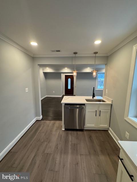 kitchen featuring sink, dark hardwood / wood-style flooring, dishwasher, pendant lighting, and white cabinets