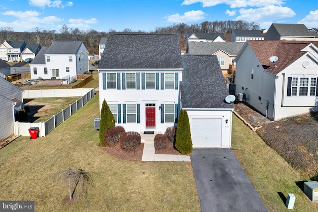 view of front of property featuring a garage and a front yard