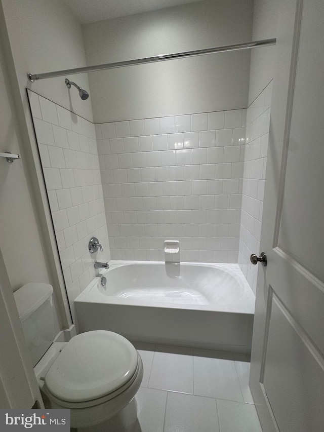 bathroom with shower / bathtub combination, toilet, and tile patterned floors