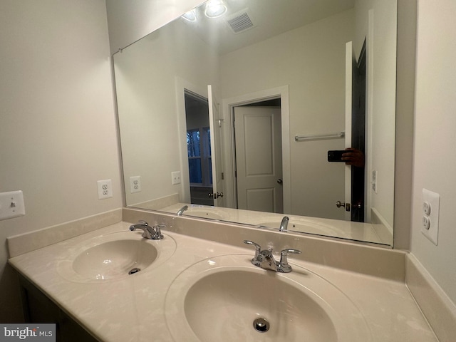 full bathroom with double vanity, a sink, and visible vents