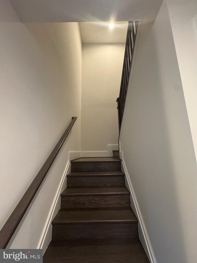 stairs featuring baseboards and wood finished floors