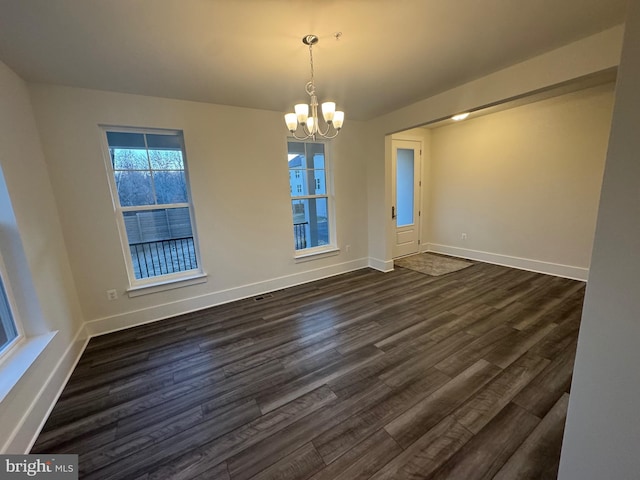 unfurnished dining area featuring baseboards, a chandelier, and dark wood-type flooring