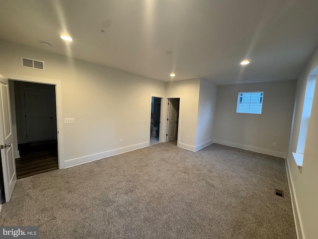 unfurnished room with recessed lighting, carpet flooring, visible vents, and baseboards