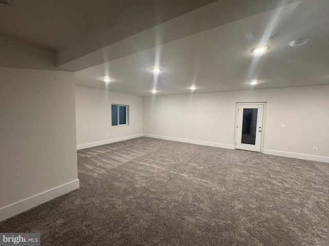 unfurnished room featuring recessed lighting, dark carpet, and baseboards