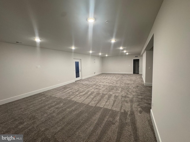 basement with visible vents, baseboards, dark colored carpet, and recessed lighting