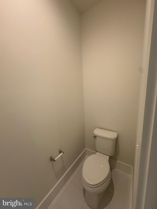 bathroom with tile patterned flooring, toilet, and baseboards