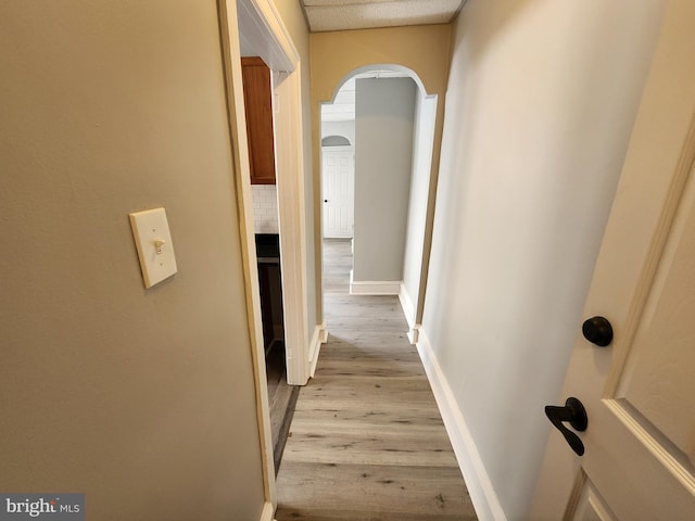 corridor with light wood-type flooring