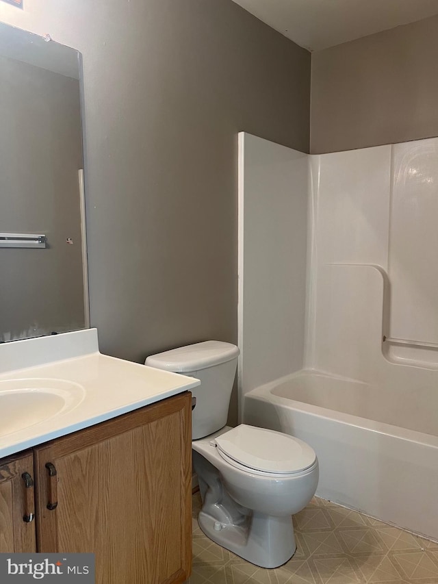 full bathroom with bathtub / shower combination, vanity, and toilet