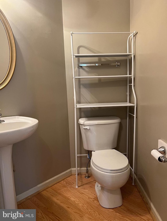 bathroom featuring sink, toilet, and hardwood / wood-style flooring