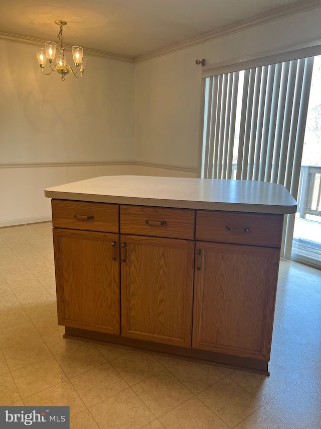 kitchen with hanging light fixtures, a chandelier, and ornamental molding