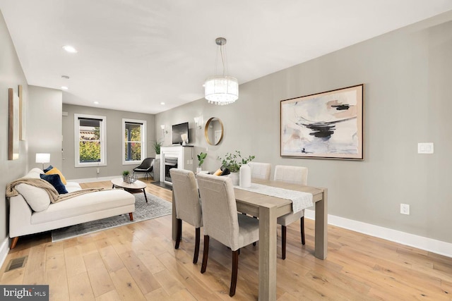 dining area featuring a notable chandelier and light hardwood / wood-style floors